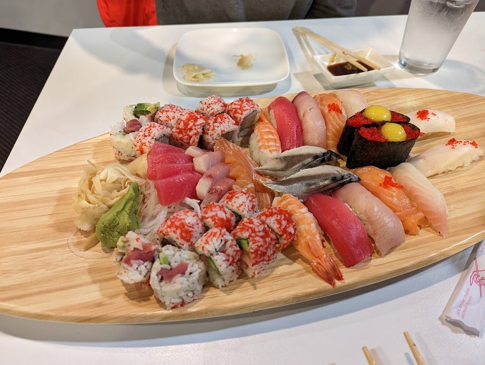 Printed menu with sushi rolls and teppanyaki.