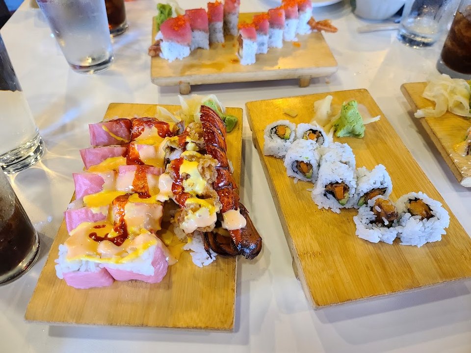 Printed menu with sushi rolls and teppanyaki.