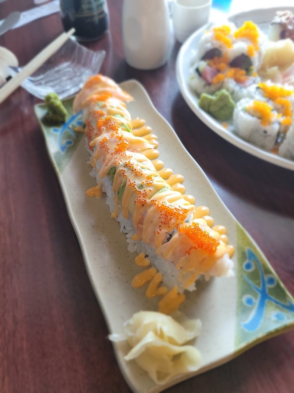 Printed menu with sushi rolls and teppanyaki.